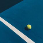 yellow tennis ball on court