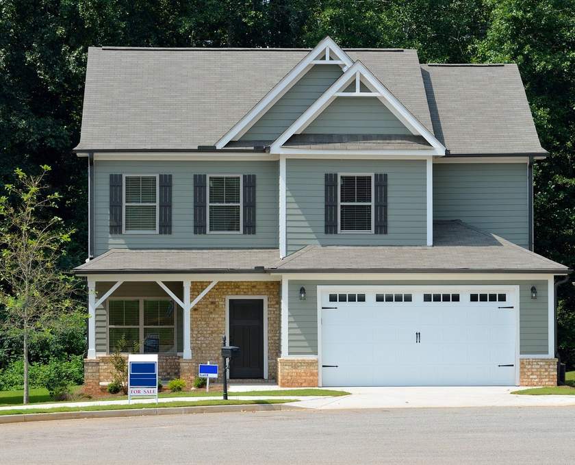 Maison verte à deux étages avec toit gris et garage blanc Maison verte à deux étages avec toit gris et garage blanc
